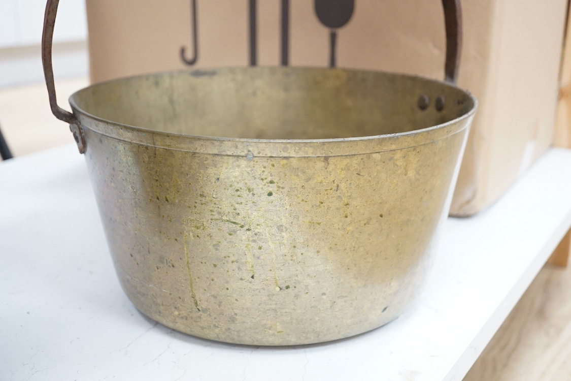 A brass preserve pot and a copper cooking pot. Brass pot 29.5cm diameter. Condition - fair to good